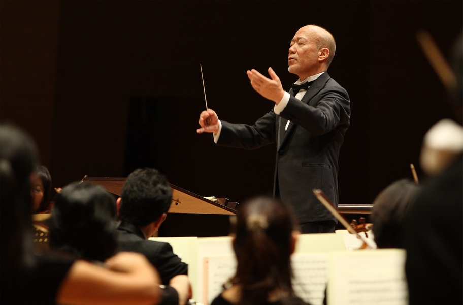 image of joe hisaichi conducting an orchestra